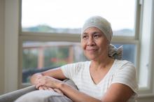 Cancer patient looking out a window and smiling 